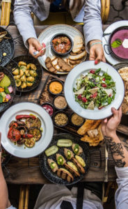 Overhead photo of people gathered around a table eating