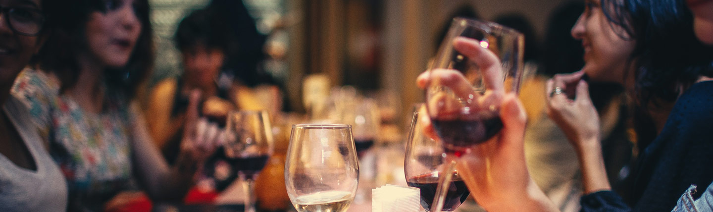 Group of people around a table talking in a restaurant