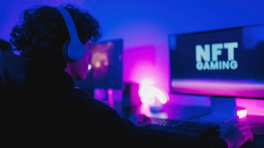 guy on computer with a screen that says NFT gaming