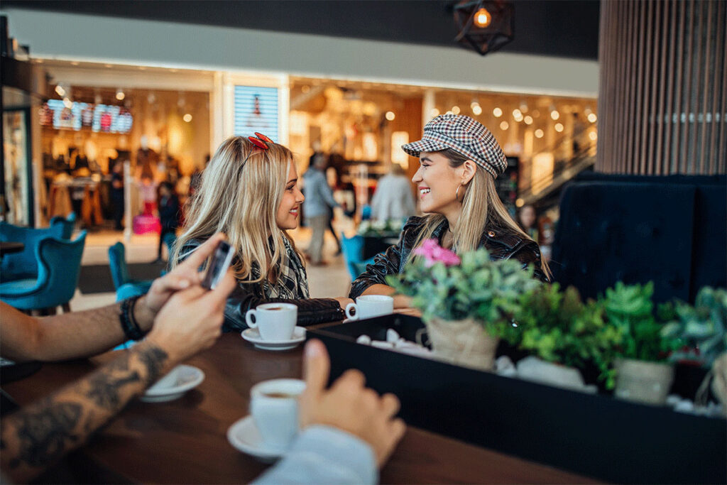 two girls talking at restaurant